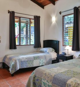 Comfortable guest room with twin beds at Villas Macondo in Tamarindo Costa Rica