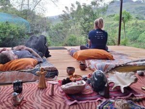 Guests relaxing during an outdoor integration and meditation session surrounded by Costa Rican nature.
