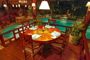Elegant poolside dining area at a luxury Costa Rica retreat featuring tropical ambiance and evening lighting.