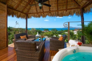 Private ocean view terrace with jacuzzi and tropical seating area at a luxury wellness retreat in Costa Rica.