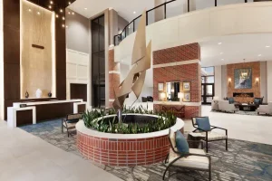 Spacious atrium lobby at Embassy Suites by Hilton Wilmington Riverfront in North Carolina.