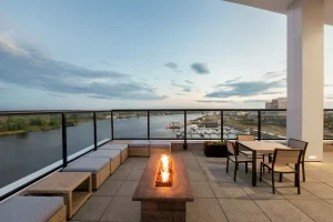 Rooftop terrace with fire pit and Cape Fear River views at Embassy Suites Wilmington Riverfront.