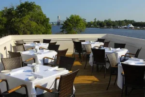 Outdoor waterfront dining terrace overlooking the Cape Fear River in Wilmington, North Carolina.