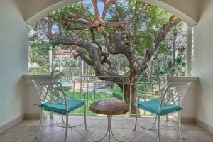 Private balcony overlooking tropical gardens at a luxury beachfront resort in Tamarindo.