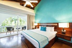 Spacious guest room with private balcony at a beachfront resort in Tamarindo, Costa Rica.