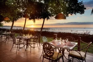 Oceanfront restaurant terrace at sunset overlooking Tamarindo Beach in Costa Rica.