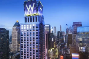 W New York Times Square hotel towering above Midtown Manhattan near Broadway and Times Square.